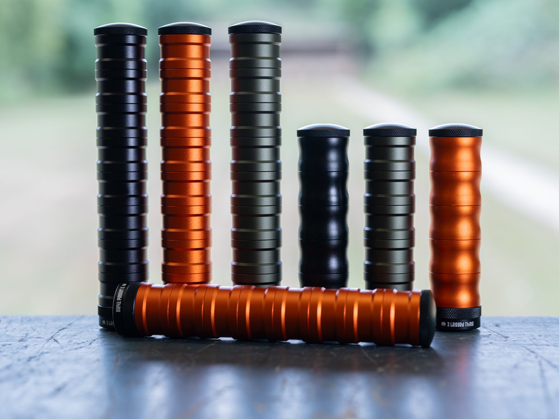 3 Legged Thing Reservoir Mods airgun moderators in orange, black and green, built from stackable chambers