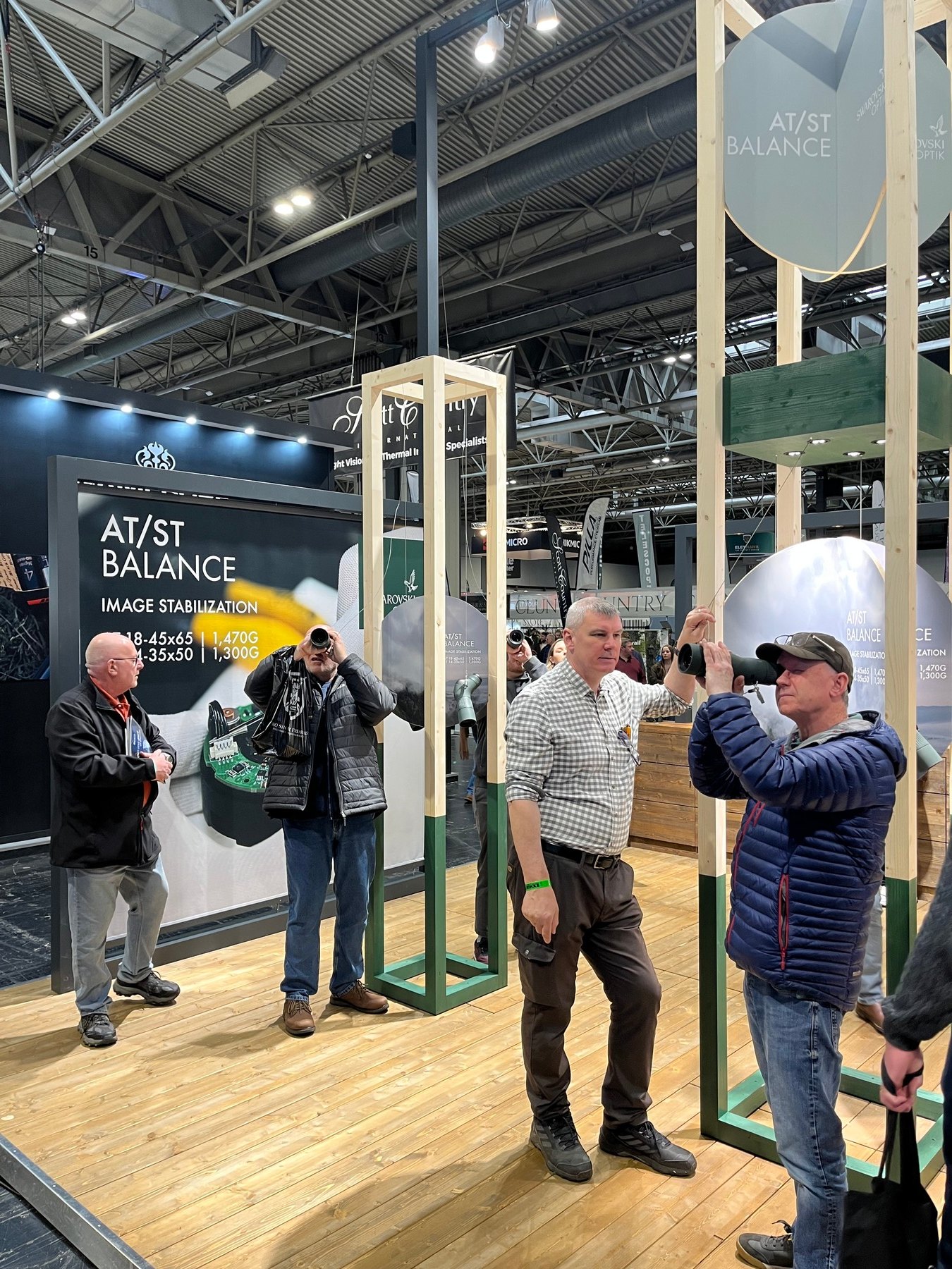 Visitors trying image-stabilised binoculars at the AT/ST Balance demonstration on the Swarovski Optik stand