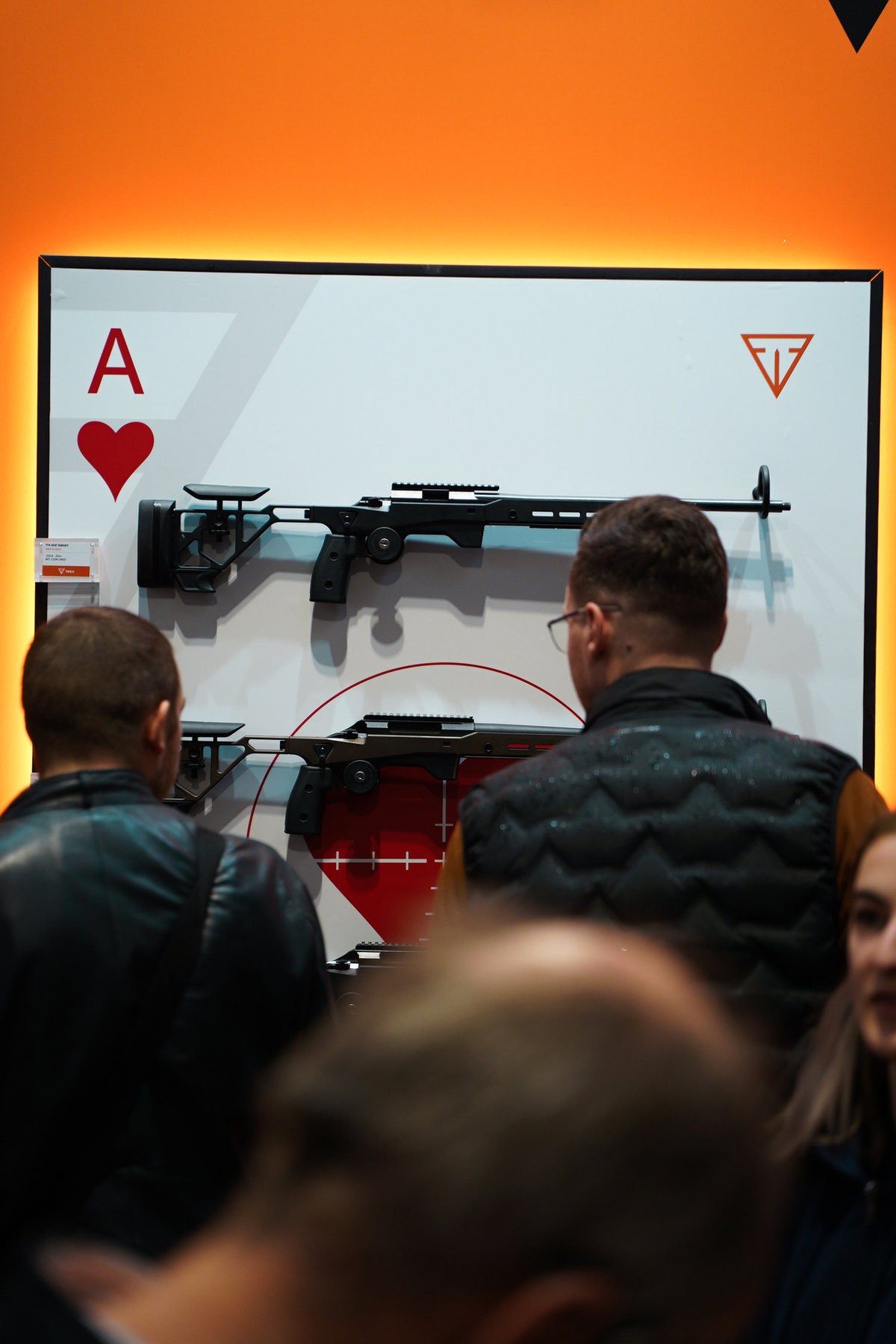 Visitors looking at a Tikka rifle display on the GMK stand