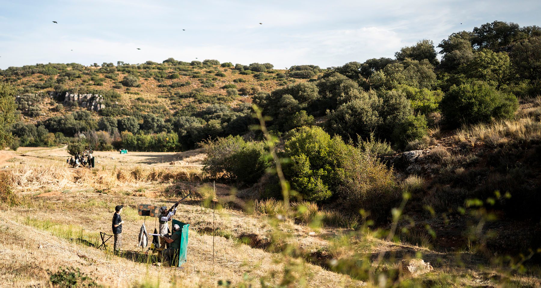 Guns on a peg during a driven partridge drive in the hills of the El Crespo Estate, Spain