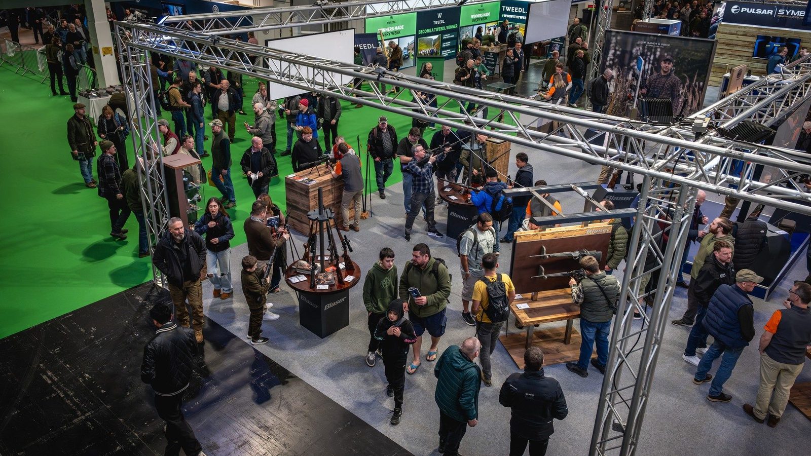 Visitors handling rifles on the Blaser stand at the British Shooting Show at the NEC Birmingham